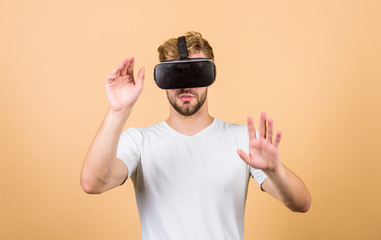 Man hipster with virtual reality headset on peach background. Entertainment and education. Virtual communication. Virtual simulation. VR for gaming. Man play game in VR glasses. Explore cyber space