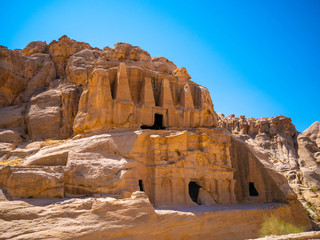 Ancient temples built into sandstone walls in the historic city of Petra, Jordan