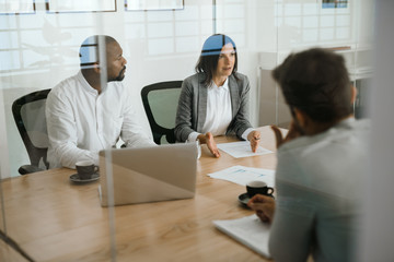 Diverse businesspeople talking together during an office meeting