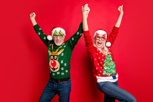 2020 is here x-mas newyear.Dream come true at midnight.Two cheerful positive comic grey white haired in cap headwear people having luck good mood raising hands up isolated bright color background