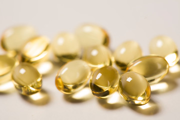 Fish oil capsules, rich in Omega 3. Closeup, isolated on white background.