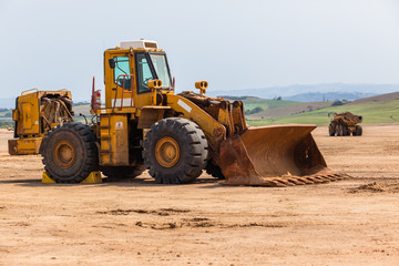Fototapeta premium Industrial Dump Truck Vehicle Moving Earth Property Development Countryside Landscape.