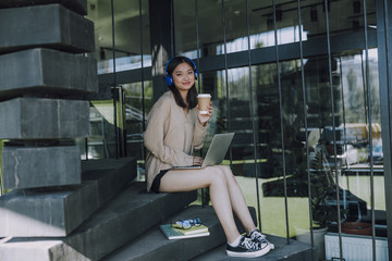 Smiling lady looking at camera on stairs