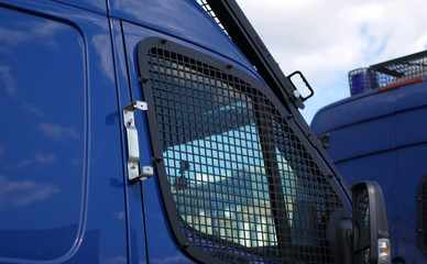 Police cars for transporting prisoners. Police buses with bars for protection at rallies and strikes.