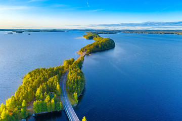 Aerial view of Pulkkilanharju Ridge, Paijanne National Park, southern part of Lake Paijanne. Landscape with drone. Blue lakes, road and green forests from above on a sunny summer day in Finland.