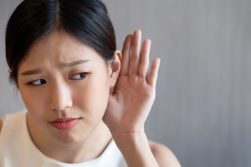 sad woman listening to bad news or suffering from hear of hearing ear, hearing loss
