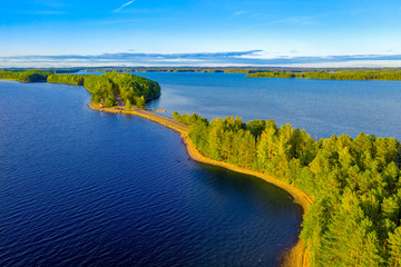Aerial view of Pulkkilanharju Ridge, Paijanne National Park, southern part of Lake Paijanne. Landscape with drone. Blue lakes, road and green forests from above on a sunny summer day in Finland.