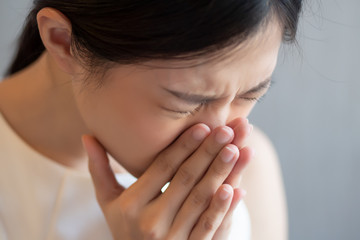 asian woman sneezing; concept of health care, body care, sickness, cold, flu, allergy, hay fever,...