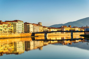 Sunset on the banks of the Arno River, Pisa, Italy.