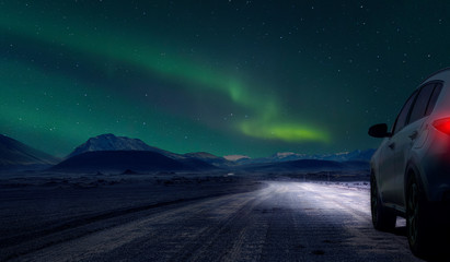 car by night on gravel  road of iceland