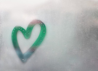 turquoise, mint heart outline painted on sweaty glass, many drops on it, inscription heart and love handmade on wet autumn foggy glass