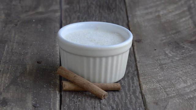 Rice pudding with cinnamon on wooden background.