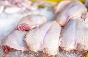Fresh raw chicken on ice in a local market.