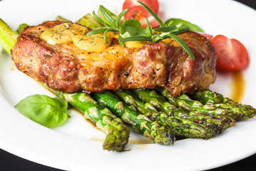 Gourmet steak with green asparagus on the plate