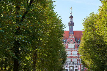 The main building of Gdansk University of Technology or Politechnika Gdanska among trees on the approaching alley