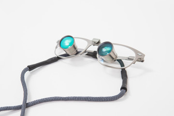 Dental medical glasses with binocular lenses, to increase