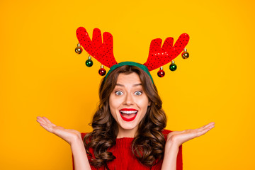 Pretty lady overjoyed with xmas decor wear head horns and knitted pullover isolated yellow background