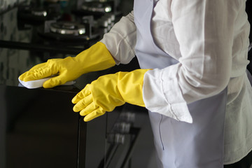 asian middle aged domestic helper woman cleaning kitchen, doing housework, housekeeping service...