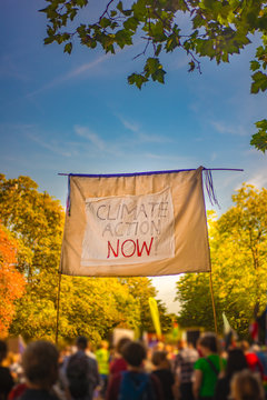 Banner Demanding Climate Action Now at March for Climate in Glasgow Scotland With Protesters and Autumn Leaves in the Background