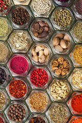 Various spices and herbs in bottles, top view