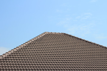tiles roof on new house with blue sky