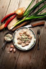 Hot meat dumplings with spicy sauce a wooden tabletop