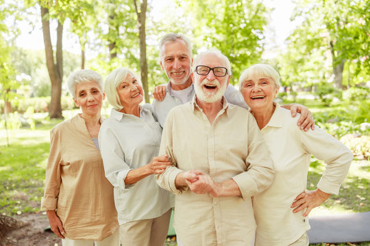Cheerful mature people standing on the street