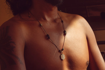 Hexagon agate druzi pendant necklace on dark skin male chest