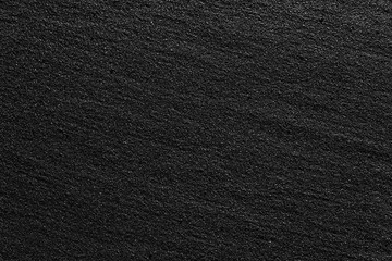 Black Sand beach macro photography. Texture of black volcanic sand for background.