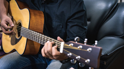 A guitarist playing an acoustic guitar