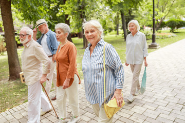 Happy senior people walking on the street