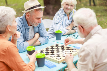 Senior people playing checkers in the park