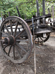 Fototapeta na wymiar Old Wooden Wagon Wheel. The Old Wooden Cart Wheel
