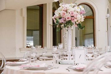 Fashionable artistic design of wedding table for classic wedding by flowers and white elements