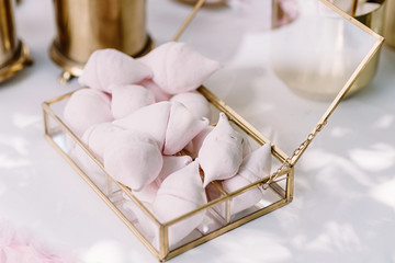 A beautiful air marshmallow in a glass box on a holiday table with sweets