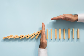 Chain Reaction In Business Concept, Businessman Intervening Chain Dominoes Toppling