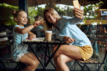Happy kid posing for photo with mum stock photo