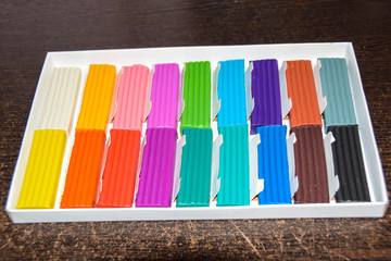 new packaging of multi-colored bright plasticine lies