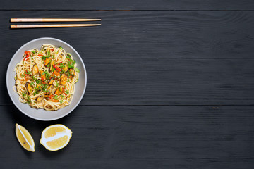 Pasta Spaghetti seafood with mussels Marinara, Typical dish of Italian pasta. top view. on a black background with a place for text, copy space