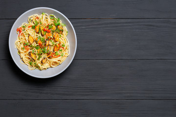 Pasta Spaghetti seafood with mussels Marinara, Typical dish of Italian pasta. top view. on a black background with a place for text, copy space