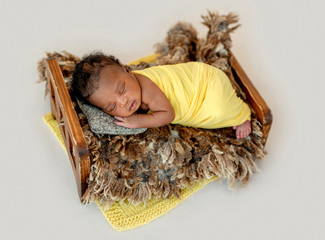 Newborn sleeping in cradle
