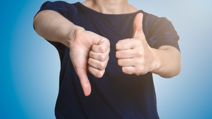 Woman showing thumbs up and thumbs down. Social media, marketing and communication © STOATPHOTO