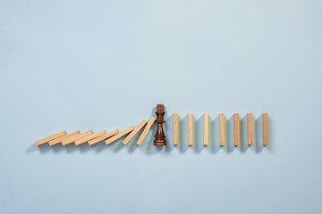 Chain Reaction In Business Concept, Leader Businessman Intervening Chain Dominoes Toppling