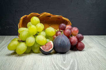 Fresh tropical fruit with ripe figs and grapes