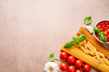 Pasta ingredients on light rustic background with copy space