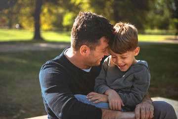 Smiling son having fun with his father
