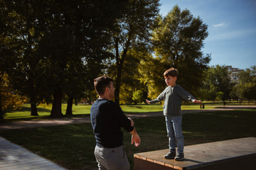 Fototapeta na wymiar Father and Son having fun in the park