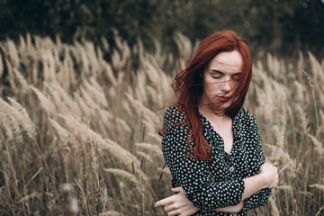 Close up portrait of young ginger sensual pretty caucasian lovely girl with freckled face in autumn...