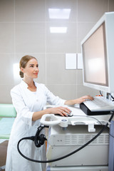 Female using modern electronic machine in hospital stock photo