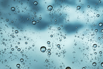 Rain on the window, natural skin of the rain The natural form of rainwater on a sky background.